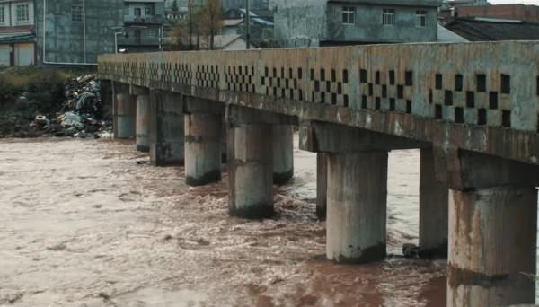 Lorsqu’ils atteignirent le pont, ils virent un mendiant qui cuisinait en dessous. (Image : Capture d’écran / YouTube)